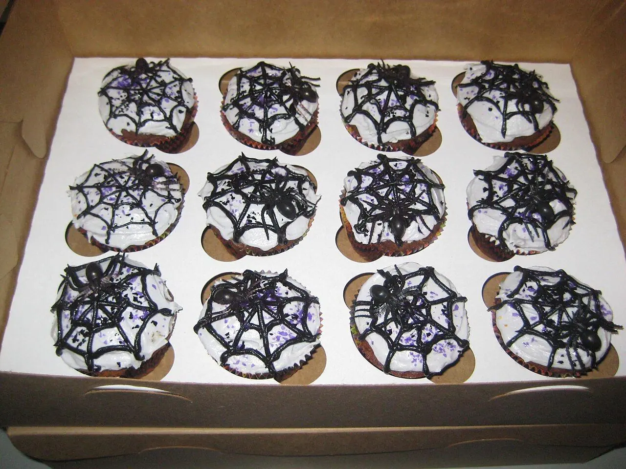Chocolate pumpkin cupcake filled with cranberry curd and topped with cinnamon buttercream.