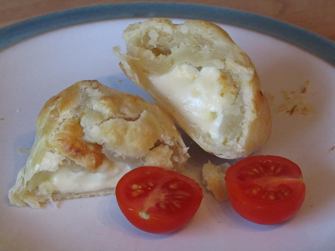 A brie cheese puff pastry pocket prepared in a kitchen in the village of Trimingham , Norfolk, United Kingdom.